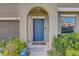 Home's entry with arched entryway, well-manicured bushes and ADT security for peace of mind at 11476 Sage Canyon Dr, Riverview, FL 33578