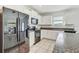 Modern kitchen featuring stainless steel appliances, granite countertops, and white cabinetry at 11476 Sage Canyon Dr, Riverview, FL 33578