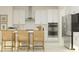 Modern kitchen with stainless steel appliances, a center island, and white cabinetry at 11543 71St E Ave, Palmetto, FL 34221