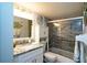Well-lit bathroom boasts elegant vanity with marble countertop and a shower with stylish tile surround at 11720 Park Blvd # 301, Seminole, FL 33772