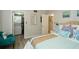 Bedroom featuring a Queen bed with decorative pillows, chair, and stacked washer/dryer at 11720 Park Blvd # 301, Seminole, FL 33772