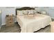 Comfortable bedroom features a Queen bed with decorative pillows and wood nightstand at 11720 Park Blvd # 301, Seminole, FL 33772