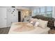 Bedroom features a Queen bed with decorative pillows and windows for natural light at 11720 Park Blvd # 301, Seminole, FL 33772