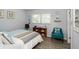 Comfortable bedroom featuring a queen-size bed, ample natural light, and inviting coastal-themed decor at 11720 Park Blvd # 301, Seminole, FL 33772