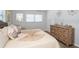 Bedroom with decorative pillows on the bed and dresser against the wall at 11720 Park Blvd # 301, Seminole, FL 33772