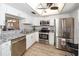 Beautiful kitchen featuring stainless appliances, granite countertops and a seamless flow to dining area at 11720 Park Blvd # 301, Seminole, FL 33772