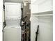 Compact laundry area featuring a stacked washer and dryer, along with additional storage space at 11720 Park Blvd # 301, Seminole, FL 33772