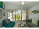 Bright living room features a ceiling fan and an abundance of natural light from the large window at 11720 Park Blvd # 301, Seminole, FL 33772