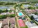 Scenic aerial view of community pool, basketball court, and surrounding homes near a lake at 12107 Fox Bloom Ave, Gibsonton, FL 33534