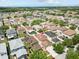 An aerial view shows the home with mature trees and a well-maintained neighborhood at 12107 Fox Bloom Ave, Gibsonton, FL 33534