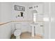 Cozy half bathroom with a pedestal sink, a decorative mirror, and neutral decor at 12107 Fox Bloom Ave, Gibsonton, FL 33534