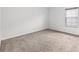 Bright bedroom featuring neutral carpet and a window offering natural light at 12107 Fox Bloom Ave, Gibsonton, FL 33534