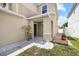 Inviting front entrance with a covered porch, manicured lawn, and decorative stone accents at 12107 Fox Bloom Ave, Gibsonton, FL 33534