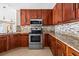 Gourmet kitchen featuring granite countertops, stainless steel appliances, and custom cabinetry at 12107 Fox Bloom Ave, Gibsonton, FL 33534