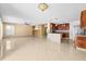 Open living space with tile floors, a ceiling fan, and easy access to the kitchen and dining area at 12107 Fox Bloom Ave, Gibsonton, FL 33534