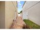 The side yard features a paver walkway and white privacy fence at 12107 Fox Bloom Ave, Gibsonton, FL 33534