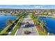 Aerial view of a community with beautiful ponds, palm trees, and well-maintained streets at 12499 Longstone Ct, New Port Richey, FL 34655
