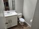 Bathroom features modern fixtures, a sink with storage and a toilet at 12499 Longstone Ct, New Port Richey, FL 34655