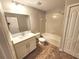 Bathroom featuring a vanity, toilet, and tub/shower combination with tile flooring at 12499 Longstone Ct, New Port Richey, FL 34655
