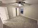 Bedroom featuring neutral walls, plush carpeting, ceiling fan, closet, and a window at 12499 Longstone Ct, New Port Richey, FL 34655