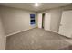 Bedroom featuring neutral walls, plush carpeting, closet, and a window letting in natural light at 12499 Longstone Ct, New Port Richey, FL 34655