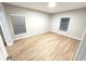 Bright bedroom with wood flooring and two windows at 12499 Longstone Ct, New Port Richey, FL 34655