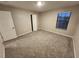 Bedroom featuring neutral walls, plush carpeting, and a window letting in natural light at 12499 Longstone Ct, New Port Richey, FL 34655