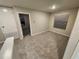 Bright bedroom featuring neutral walls, plush carpeting, and a window letting in natural light at 12499 Longstone Ct, New Port Richey, FL 34655