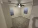 Bedroom featuring neutral walls, plush carpeting, ceiling fan, and a window letting in natural light at 12499 Longstone Ct, New Port Richey, FL 34655
