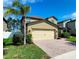 Attractive two-story home featuring a large two car garage and lush green lawn at 12499 Longstone Ct, New Port Richey, FL 34655