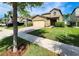 Beautifully landscaped front yard with a two-story home and paver driveway at 12499 Longstone Ct, New Port Richey, FL 34655