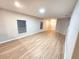 Empty living room with wood floors and bright lighting from the windows at 12499 Longstone Ct, New Port Richey, FL 34655