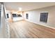 Open-concept living area with wood floors and connecting kitchen and dining area at 12499 Longstone Ct, New Port Richey, FL 34655