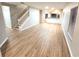 Spacious living room featuring wood floors, staircase, and modern windows at 12499 Longstone Ct, New Port Richey, FL 34655
