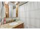 Bathroom features wood cabinetry, granite countertop, and shower with curtain at 12736 Wood Trail Blvd, Tampa, FL 33625