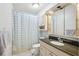 Bathroom featuring a shower and bathtub combination and a vanity with a large mirror at 12736 Wood Trail Blvd, Tampa, FL 33625