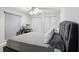 Cozy bedroom featuring neutral walls, gray bed, and a modern computer desk at 12736 Wood Trail Blvd, Tampa, FL 33625