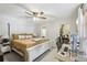 Bedroom featuring a white bed frame, a ceiling fan, and an office space at 12736 Wood Trail Blvd, Tampa, FL 33625