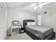 Bright bedroom features a ceiling fan, gray bed, carpet flooring and closet at 12736 Wood Trail Blvd, Tampa, FL 33625