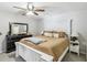Bedroom featuring a white bed frame, ceiling fan and dresser with mirror at 12736 Wood Trail Blvd, Tampa, FL 33625