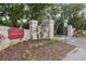 Townhomes of Country Wood entrance sign with landscaping and decorative stone pillars at 12736 Wood Trail Blvd, Tampa, FL 33625