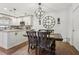 This dining area features wood floors, a large clock, and an updated chandelier at 12736 Wood Trail Blvd, Tampa, FL 33625