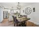 The dining room features wood floors, a large clock, and an updated chandelier at 12736 Wood Trail Blvd, Tampa, FL 33625