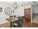 The dining room features wood floors, a large clock, and an updated chandelier at 12736 Wood Trail Blvd, Tampa, FL 33625