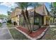 Angle view of the building's exterior showing palm trees, mulch beds, screened porch, and a portion of the walkway at 12736 Wood Trail Blvd, Tampa, FL 33625