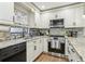 Bright kitchen with stainless steel appliances, granite countertops, and ample cabinet space at 12736 Wood Trail Blvd, Tampa, FL 33625
