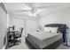 The main bedroom has lots of space and features a desk setup and ceiling fan at 12736 Wood Trail Blvd, Tampa, FL 33625