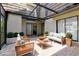 Inviting outdoor patio with stylish wicker furniture, covered with a glass roof and natural light at 12736 Wood Trail Blvd, Tampa, FL 33625