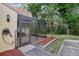 View of a screened porch with tile flooring and an outdoor hose-holder next to a narrow walkway at 12736 Wood Trail Blvd, Tampa, FL 33625