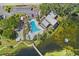 An aerial view of a community featuring a pool, clubhouse, and well-kept grounds at 14130 Rosemary Ln # 1202, Largo, FL 33774